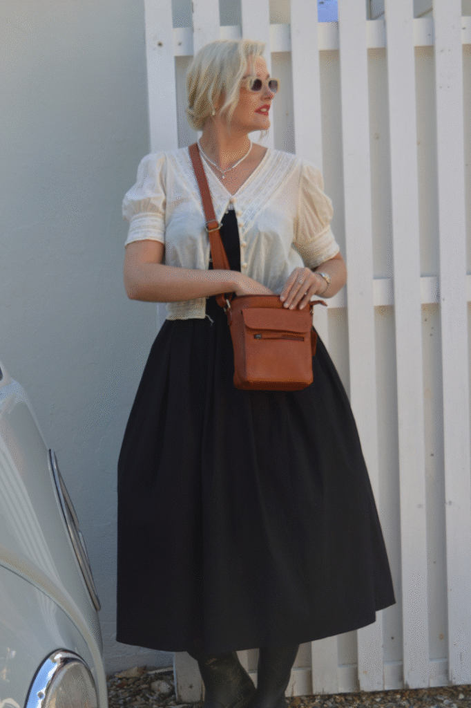 woman wearing a Hide & Seek tan leather crossbody bag